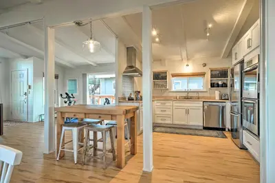 a large kitchen with a wooden table and chairs at Bethel Island Sanctuary with Dock and Boathouse in Oakley