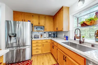 a kitchen with wooden cabinets and a stainless steel refrigerator at Tahoe's Stunner in Tahoe Vista