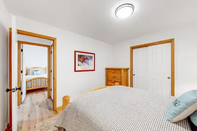 a white bedroom with a bed and a window at Tahoe's Stunner in Tahoe Vista
