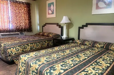 a hotel room with two beds in a room at Sunstar Inn Los Banos near I-5 in Los Banos