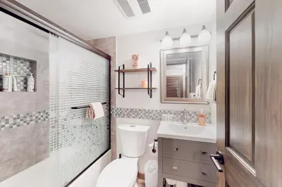 a bathroom with a toilet and a sink and a mirror at Truckee Treat in Kingswood Estates