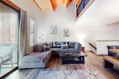 a living room with a couch and a table at Truckee Treat in Kingswood Estates