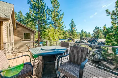 a deck with a table and chairs on a balcony at Alpine Luxury in Zephyr Cove