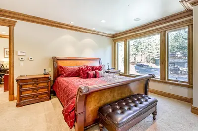 a bedroom with a large bed and a window at Alpine Luxury in Zephyr Cove