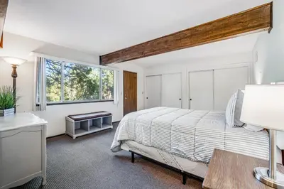 a bedroom with a bed and a window at Redwood Escape in Arnold