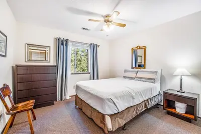 a bedroom with a bed and a ceiling fan at Redwood Escape in Arnold