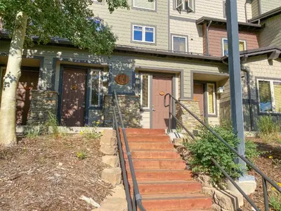 a house with a staircase leading to the front door at Mammoth Green #214 condo in Mammoth Lakes