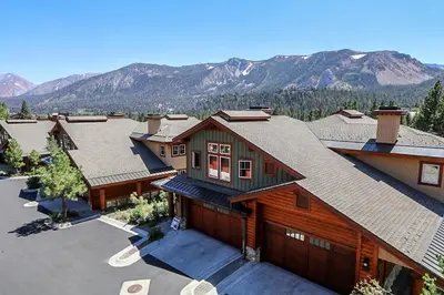 an aerial view of a house with mountains in the background at Three-Bedroom Townhouse in Mammoth Lakes