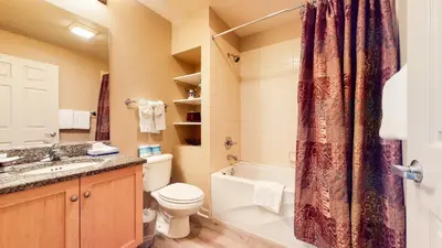 a bathroom with a toilet and a sink and a shower at Mammoth Green #111 condo in Mammoth Lakes