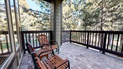 two wooden benches sitting on a screened in porch at Mammoth Green #111 condo in Mammoth Lakes