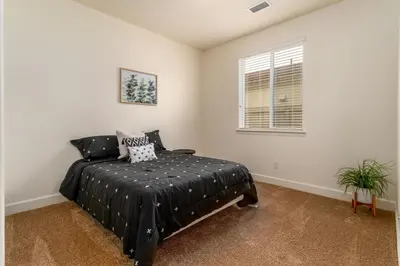 a bedroom with a bed and a window at Dream Family Home in South Reno 4 bed 30 Min to Lake Tahoe in Steamboat