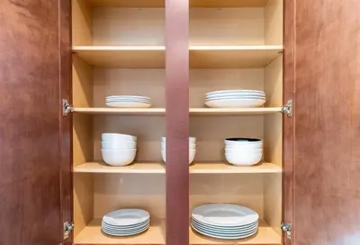 a cupboard with plates and bowls in it at Dream Family Home in South Reno 4 bed 30 Min to Lake Tahoe in Steamboat