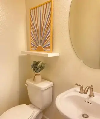 a bathroom with a toilet and a sink and a mirror at Dream Family Home in South Reno 4 bed 30 Min to Lake Tahoe in Steamboat