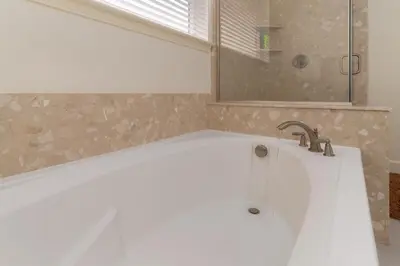 a white bath tub with a faucet in a bathroom at Dream Family Home in South Reno 4 bed 30 Min to Lake Tahoe in Steamboat