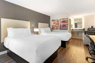 a hotel room with two beds and a desk at Best Western Plus Rancho Cordova Inn in Rancho Cordova