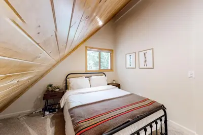 a bedroom with a bed and a wooden ceiling at Truckee Secret in Truckee