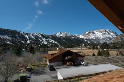 a house with snow covered mountains in the background at Rr-interlaken 19 in June Lake