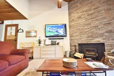 a living room with a couch and a fireplace at COZY Condo at Canyon Lodge! Sleeps 8, a walk to Canyon Lodge in Mammoth Lakes