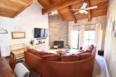 a living room with a couch and a tv at COZY Condo at Canyon Lodge! Sleeps 8, a walk to Canyon Lodge in Mammoth Lakes