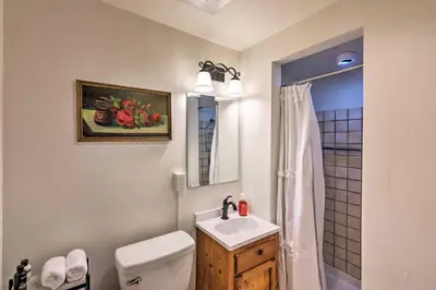 a bathroom with a sink and a toilet and a mirror at Wine Country Escape with Hot Tub in River Pines! in River Pines