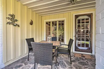 a patio with a table and chairs on a porch at Wine Country Escape with Hot Tub in River Pines! in River Pines