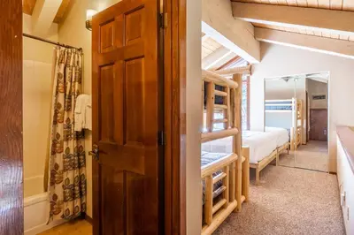 a room with a bunk bed and a door at Sunrise 9 in Mammoth Lakes