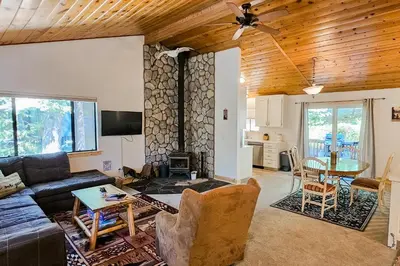 a living room with a couch and a table at Cabin In The Woods in Arnold