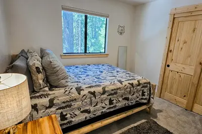 a bedroom with a bed and a window at Cabin In The Woods in Arnold