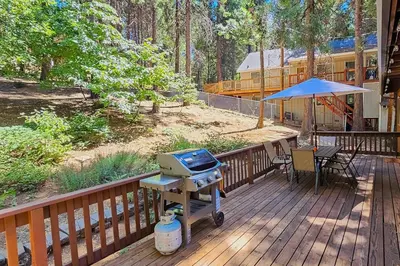 a grill on the deck of a house at Cabin In The Woods in Arnold