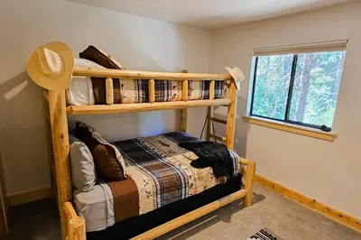 a bedroom with two bunk beds and a window at Cabin In The Woods in Arnold