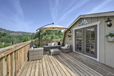 a wooden deck with chairs and an umbrella at Family Home Near Kings and Sequoia National Parks! in Squaw Valley