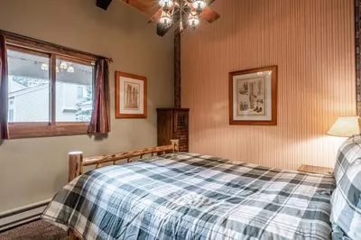 a bedroom with a bed and a window at Mammoth Creek Townhome # 40 Updated 2 bedrooms and Loft 2 and half bath Steps to free town shuttle stop in Mammoth Lakes