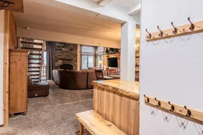 a living room with a table and a couch at Mammoth Creek Townhome # 40 Updated 2 bedrooms and Loft 2 and half bath Steps to free town shuttle stop in Mammoth Lakes