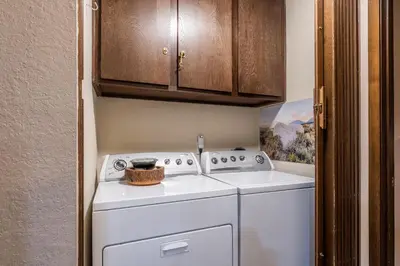 a washer and dryer in a small room at Mammoth Creek Townhome # 40 Updated 2 bedrooms and Loft 2 and half bath Steps to free town shuttle stop in Mammoth Lakes