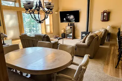 a living room with a wooden table and chairs at Tahoe Donner Escape in Truckee