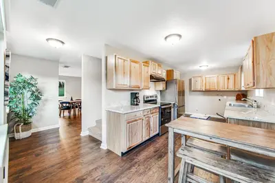 a kitchen with wooden cabinets and a dining room at Wildflower Landing in Groveland