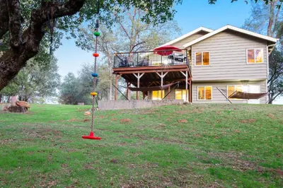 a house with a playground in the yard at Wildflower Landing in Groveland
