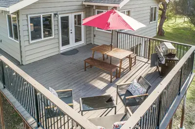 a wooden deck with a table and an umbrella at Wildflower Landing in Groveland