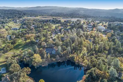 an aerial view of a park with trees and a lake at Wildflower Landing in Groveland