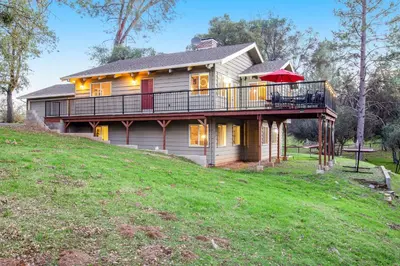 a house with a deck on top of a hill at Wildflower Landing in Groveland
