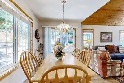 a dining room and living room with a table and chairs at Little Pinecone Retreat in Truckee