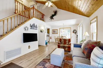 a living room with a couch and a tv at Little Pinecone Retreat in Truckee