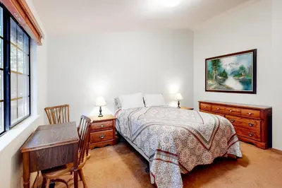a bedroom with a bed and a table and a desk at Hikers Haven in Arnold