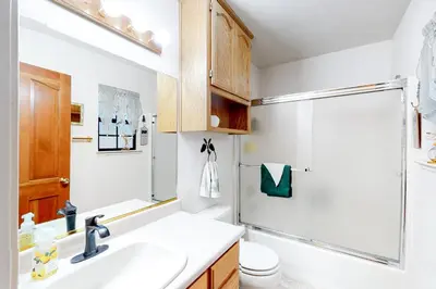 a bathroom with a sink and a shower at Hikers Haven in Arnold