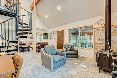 a living room with two chairs and a staircase at The Truckee Vibe in Soda Springs