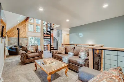 a living room with a couch and a table at The Truckee Vibe in Soda Springs