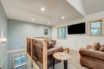 a living room with a couch and a tv at The Truckee Vibe in Soda Springs