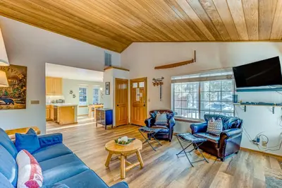 a living room with a blue couch and chairs at Mountainside Retreat in Truckee