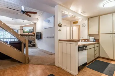 a kitchen with a ceiling fan and a staircase at New Listing 2 bedroom and Loft 2 bath Summit E Bldg 16 condo sleeps 8 Steps to Eagle Lodge Chair 15 in Mammoth Lakes