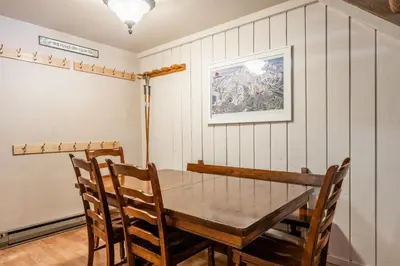 a dining room with a wooden table and chairs at New Listing 2 bedroom and Loft 2 bath Summit E Bldg 16 condo sleeps 8 Steps to Eagle Lodge Chair 15 in Mammoth Lakes